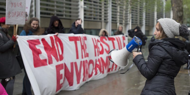 Banner: 'END THE HOSTILE ENVIRONMENT'